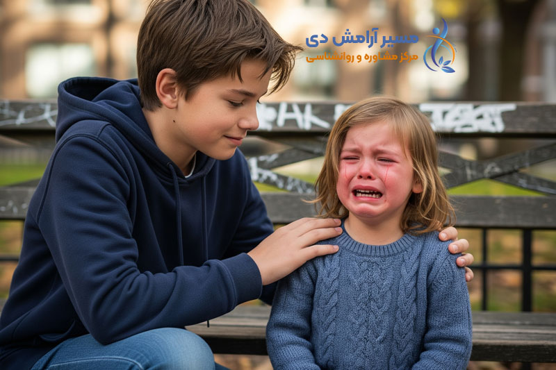 تفاوت بلوغ زودرس و بلوغ عاطفی: پسری بزرگتر با آرامش به کودک گریان کمک می‌کند.
